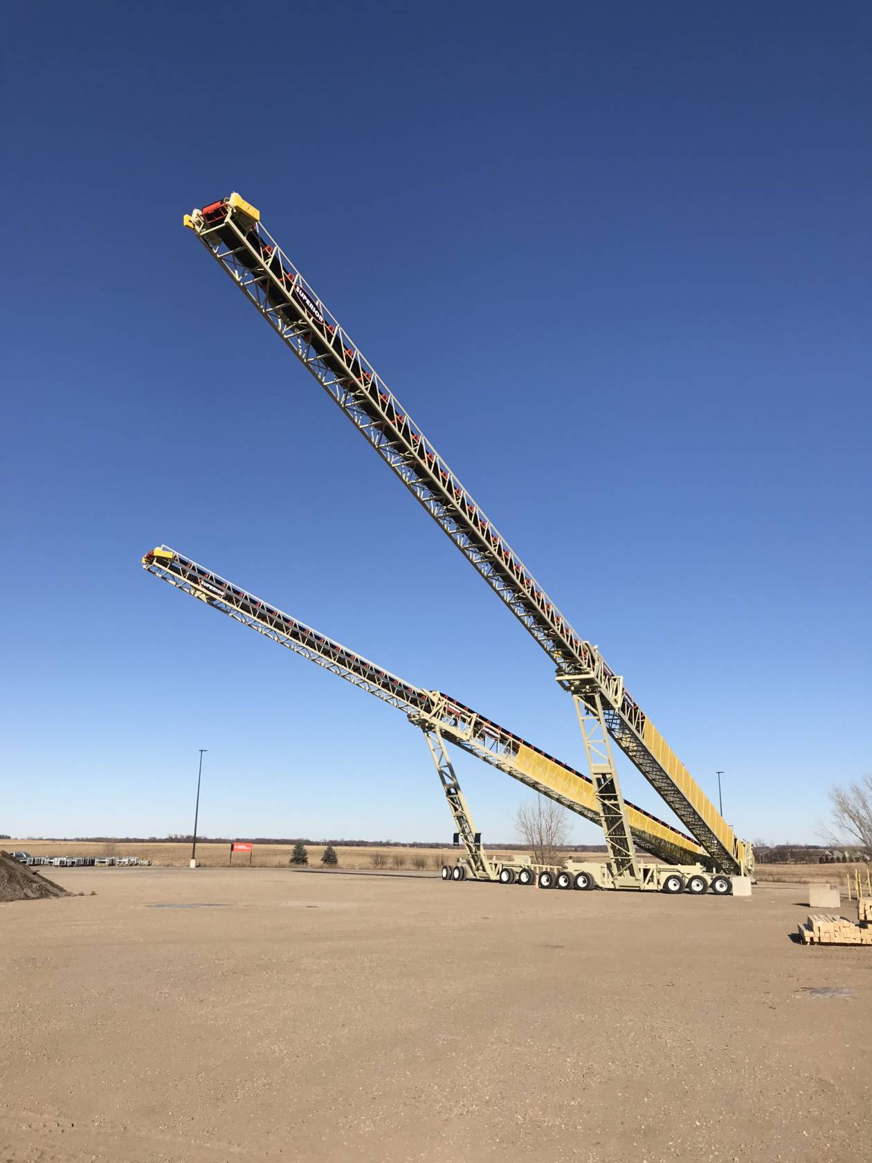 The 210′ (64m) long TeleStacker® Conveyor is shown next to a shorter model…a 170′ (52m).