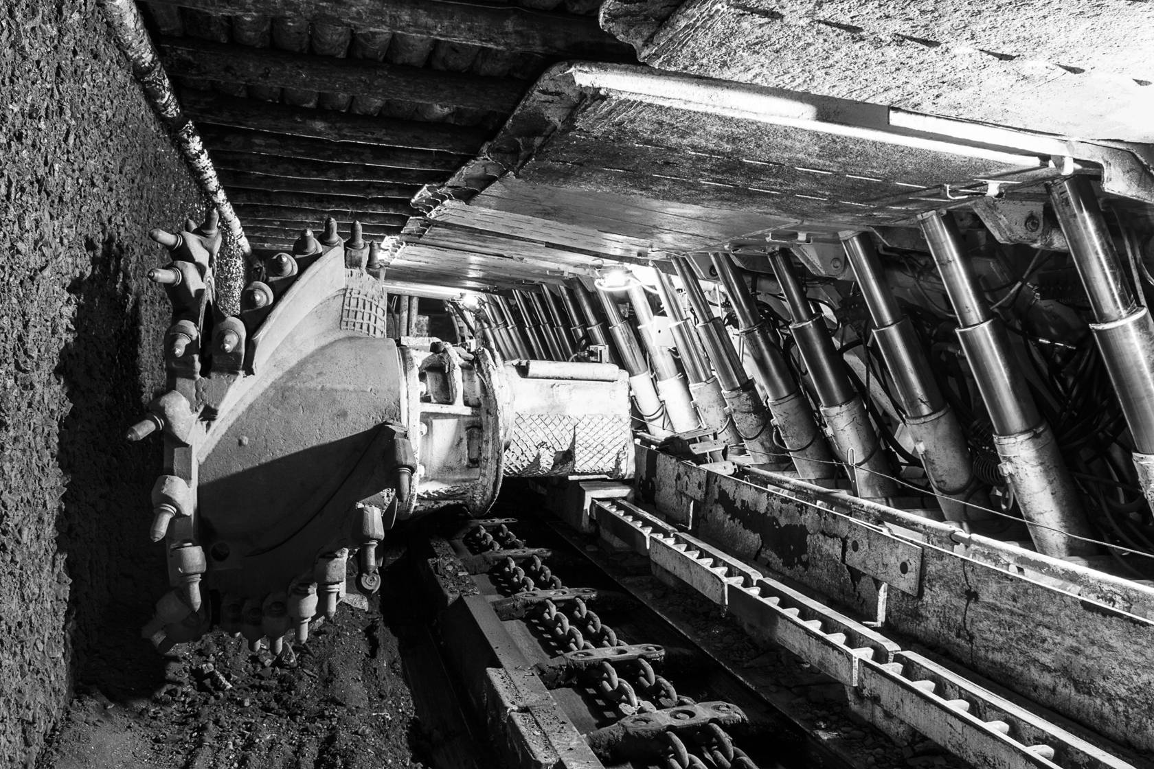 Longwall Mining: Shearer, with two rotating cutting drums and movable hydraulic powered roof supports called shields.