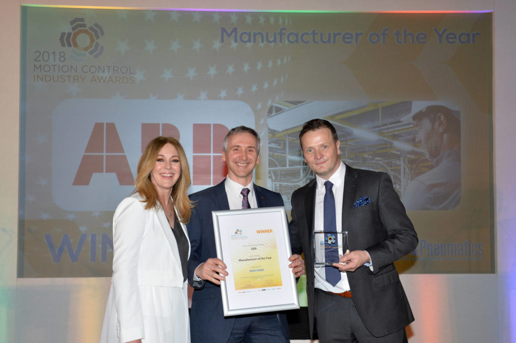 Andy Preston of ABB accepts the MCI Manufacturer of the Year award from Helen Fospero, host, and Ryan Fuller of category sponsor Hydraulics & Pneumatics magazine