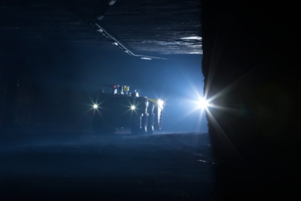 Scooptram ST14 in backlight in underground mine